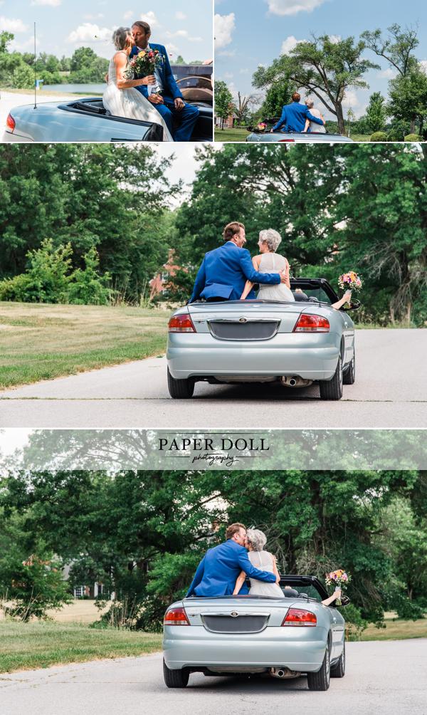 Bride and groom riding in a blue convertible after their wedding