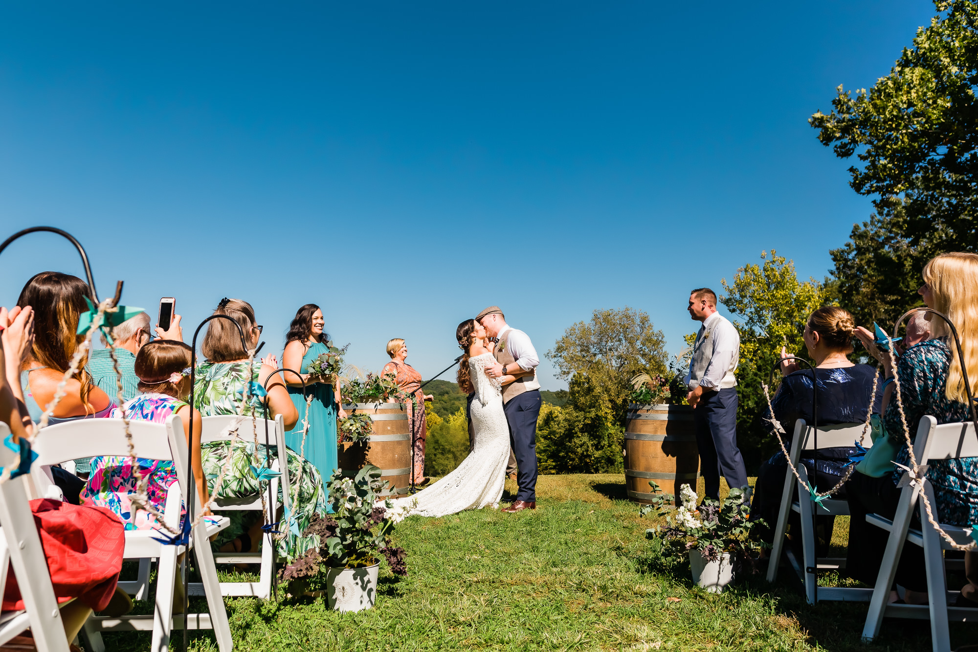 First kiss at a fall wedding ceremony outside at Chaumette Winery near St. Louis