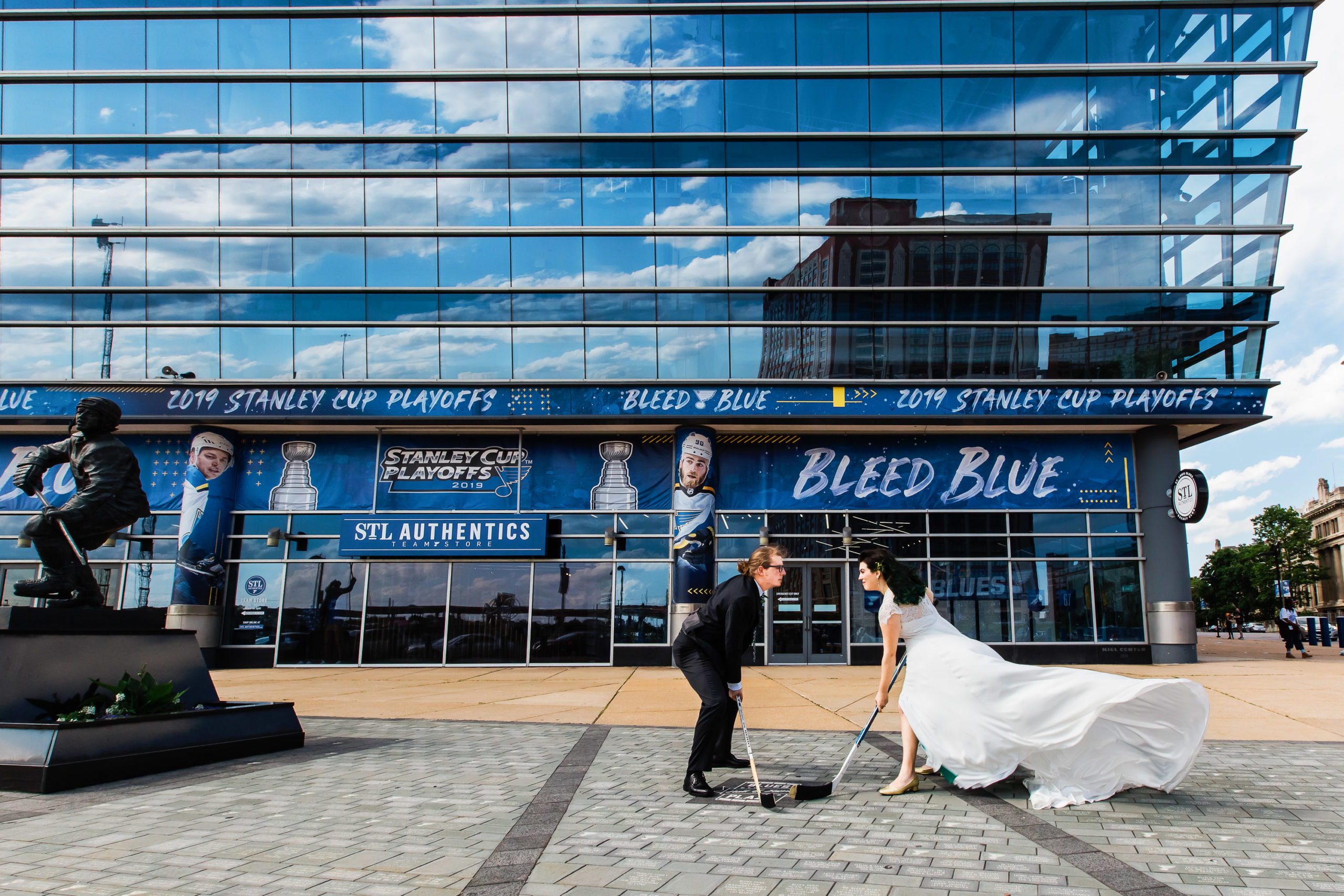 St. Louis Blues wedding photo of a couple with hockey sticks