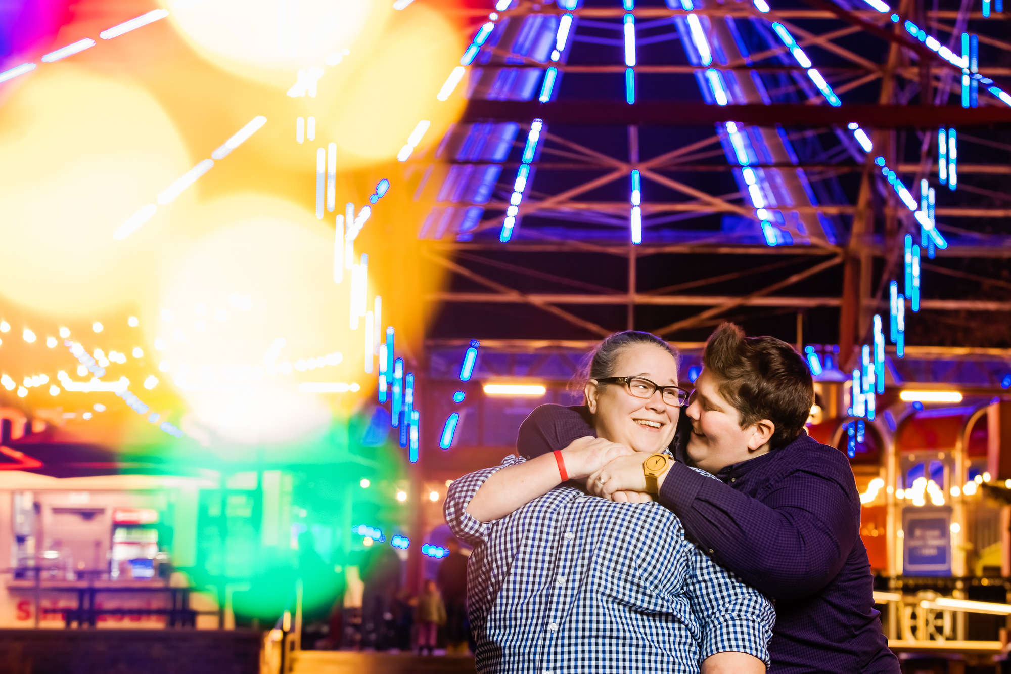 Colorful LGBT engagement photo of a lesbian couple at The St. Louis Wheel