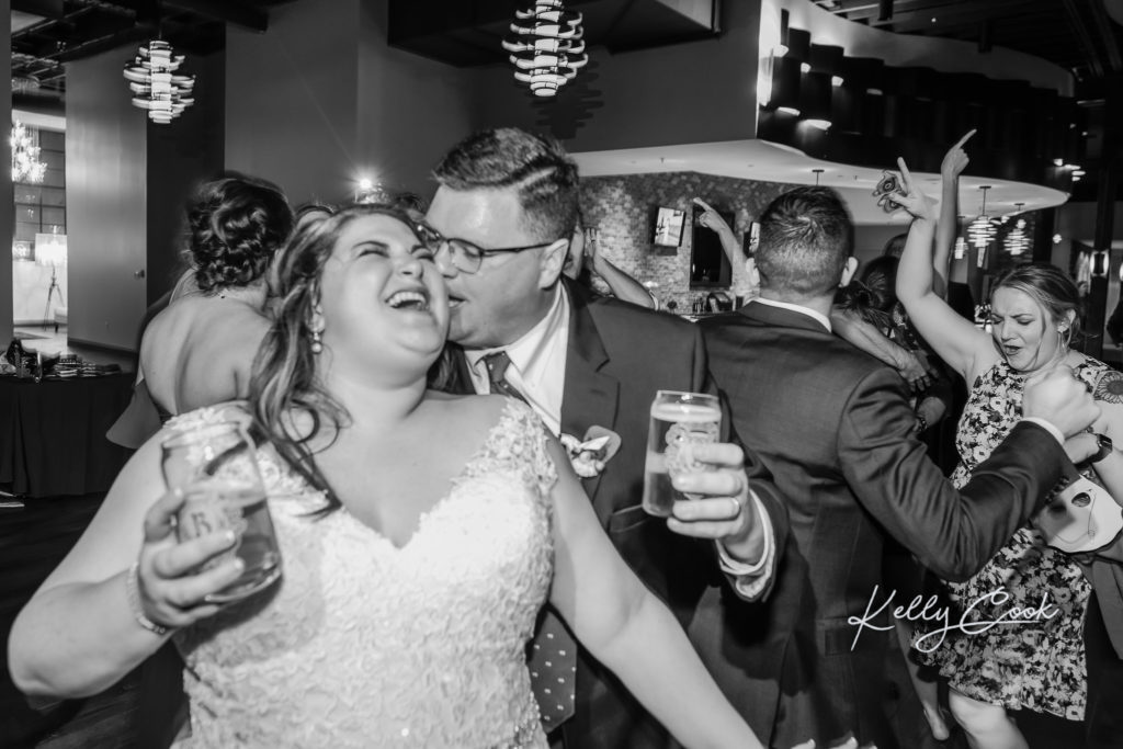 Bride and groom partying their asses off together at the wedding reception at The Caramel Room at Bissinger's