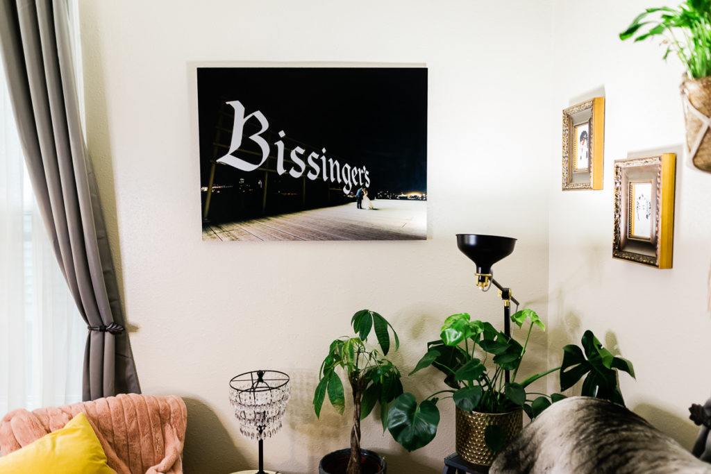 Photo of a metal print of a wedding photo hanging on a living room wall
